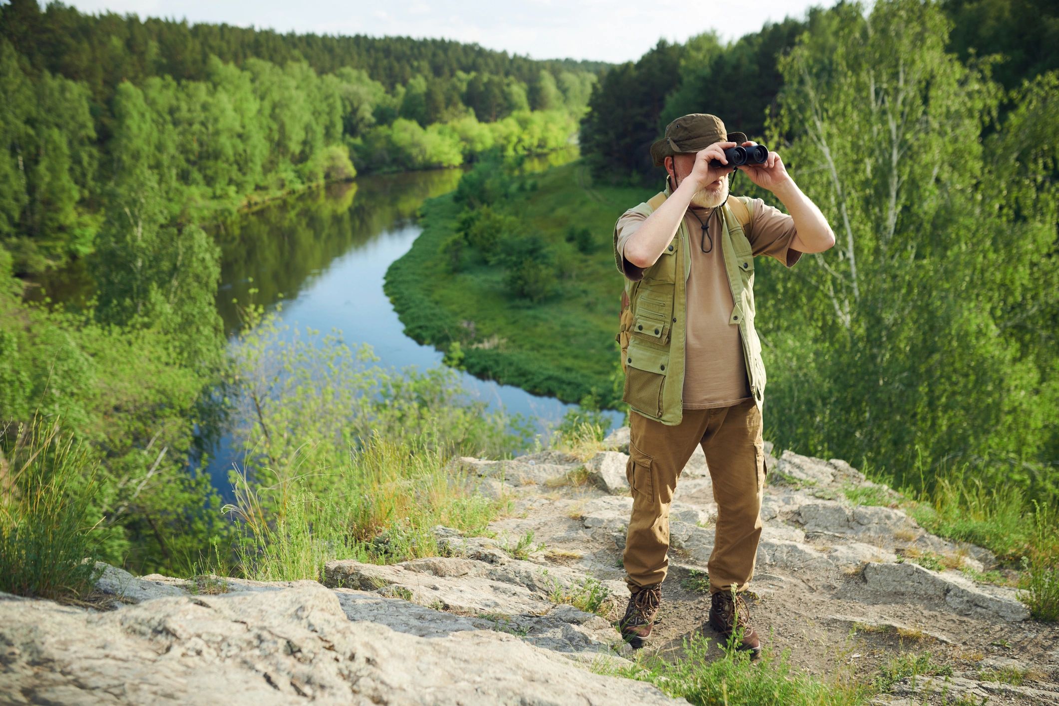 Wildlife observer scanning outdoor habitat